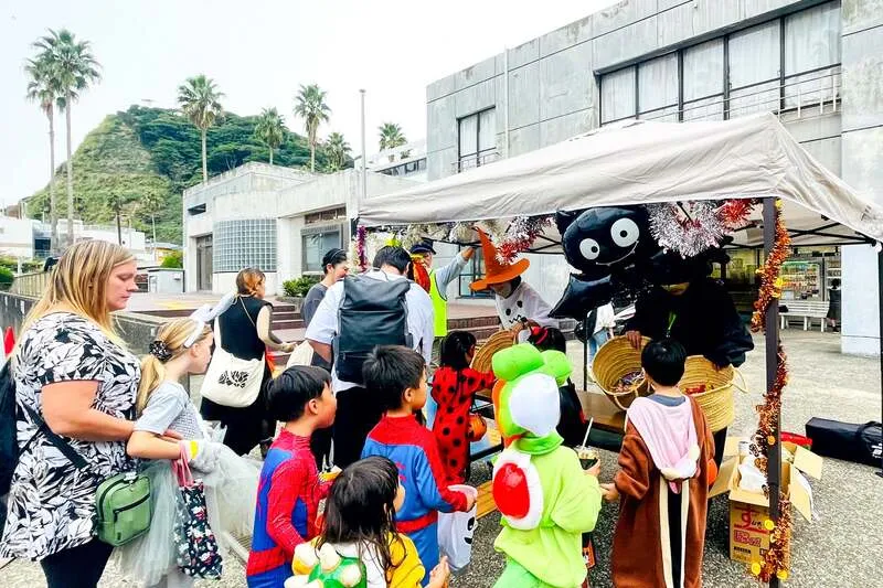 地元の店舗や住民からお菓子を受け取る子供たち
